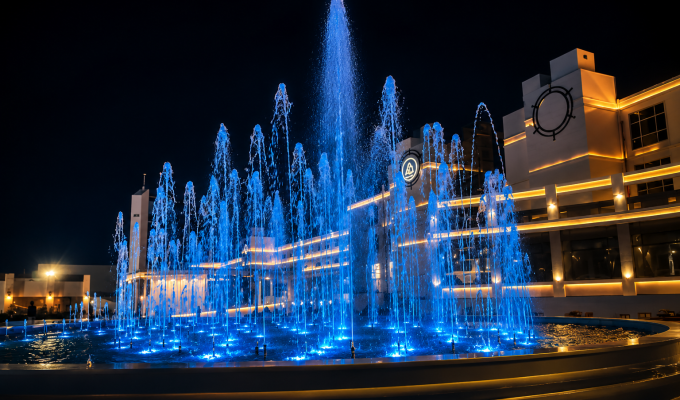 Premium architectural fountain with dynamic blue illuminated water jets at night